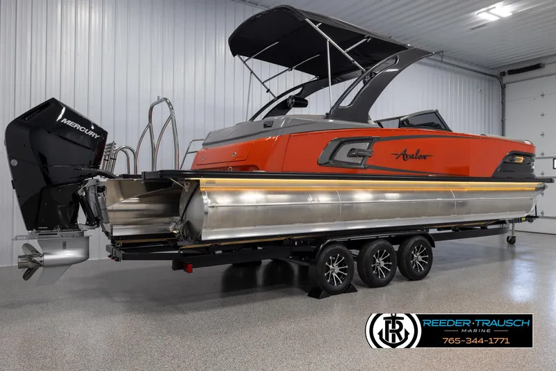 Slide: The Image of 2024 Avalon 2785 Excalibur EL pontoon boat in showroom with Mercury outboard motor. - 12