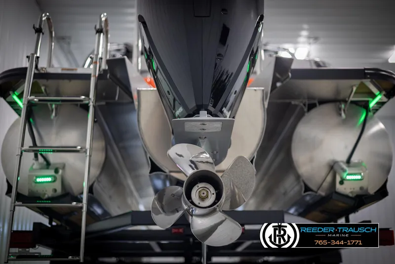 Slide: The Image of 2024 Avalon 2785 Excalibur EL pontoon boat with propeller and ladder in a showroom. - 13