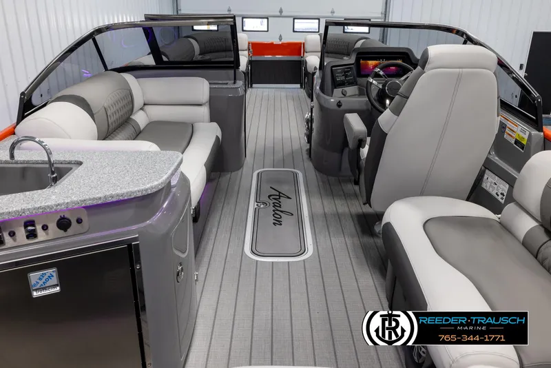 Slide: The Image of Interior of 2024 Avalon 2785 Excalibur EL pontoon boat with luxurious seating and modern dashboard. - 22