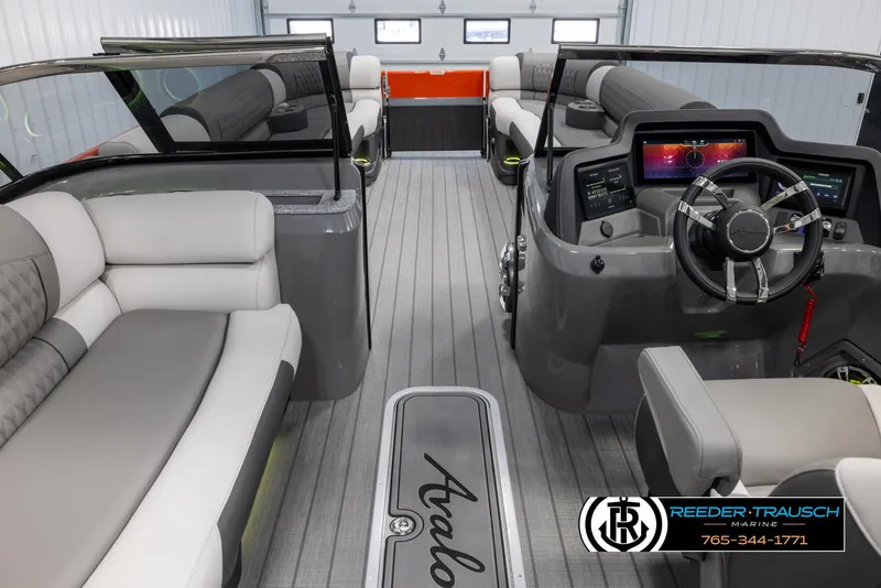 Slide: The Image of 2024 Avalon 2785 Excalibur EL luxury pontoon boat interior with modern dashboard and plush seating. - 23
