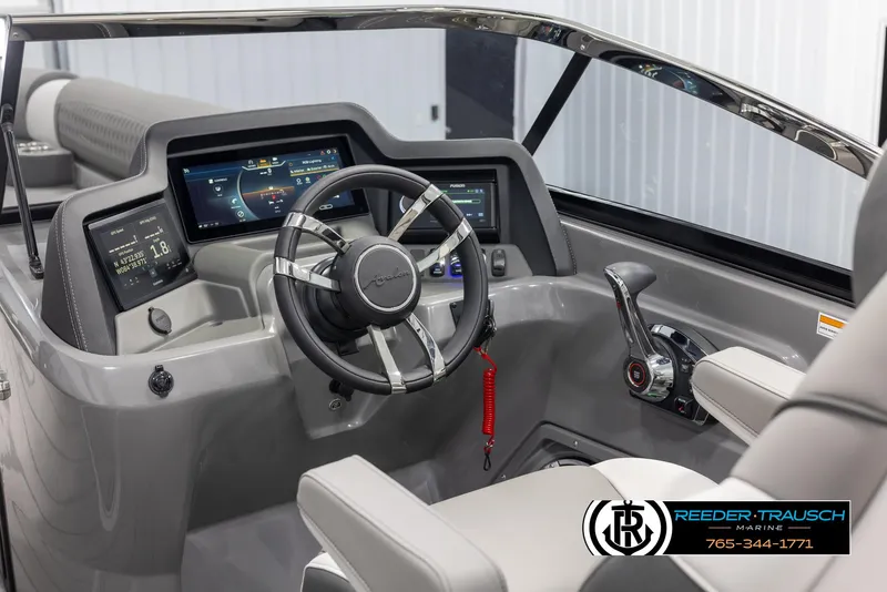 Slide: The Image of 2024 Avalon 2785 Excalibur EL boat dashboard with modern controls and steering wheel. - 43