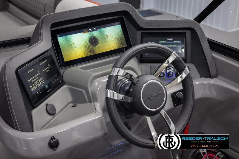 Slide: The Image of 2024 Avalon 2785 Excalibur EL boat dashboard with advanced digital displays and steering wheel. - 44