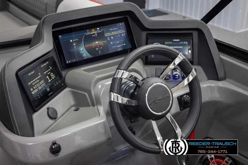Slide: The Image of 2024 Avalon 2785 Excalibur EL boat dashboard with advanced digital displays and steering wheel. - 45