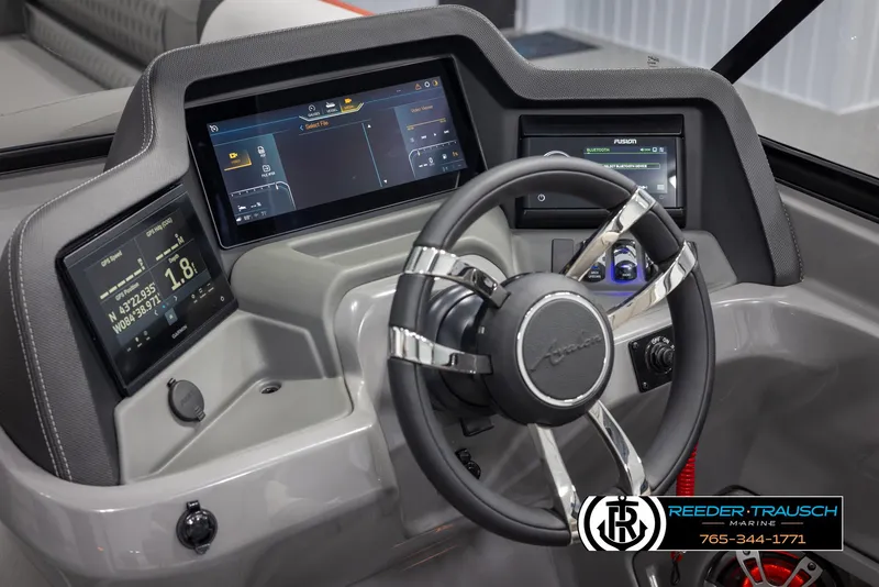 Slide: The Image of 2024 Avalon 2785 Excalibur EL boat dashboard with advanced digital displays and steering wheel. - 46