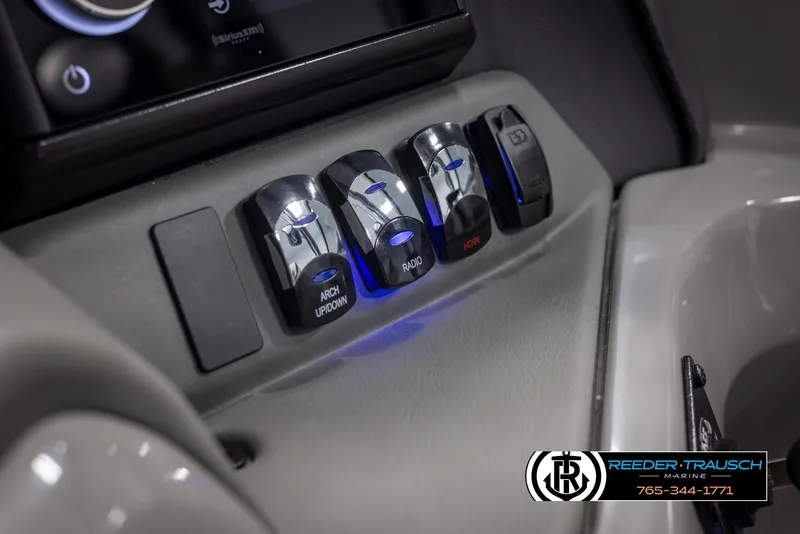 Slide: The Image of Control panel of 2024 Avalon 2785 Excalibur EL boat with illuminated switches. - 49