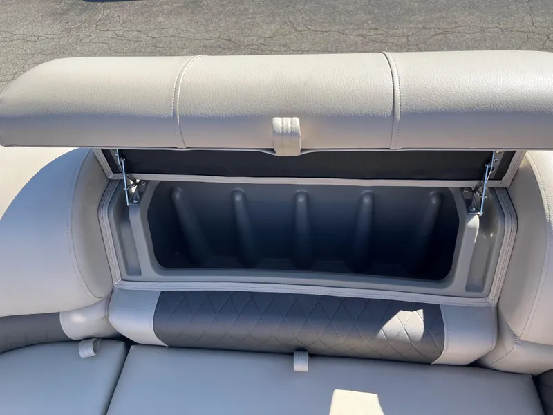 Slide: The Image of 2024 Sun Tracker Party Barge 22 RF XP3 seat storage compartment, open and empty. - 11