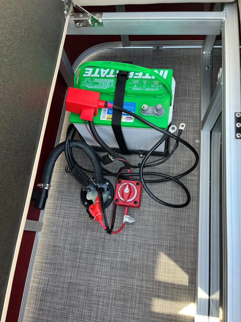 Slide: The Image of 2024 Sun Tracker Party Barge 22 RF XP3 battery compartment with wiring and switch. - 14