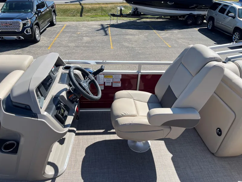 Slide: The Image of 2024 Sun Tracker Party Barge 22 RF XP3 interior with captain's chair and steering console. - 4
