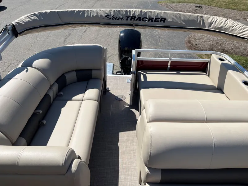 Slide: The Image of 2024 Sun Tracker Party Barge 22 RF XP3 interior with beige seating and motor. - 7
