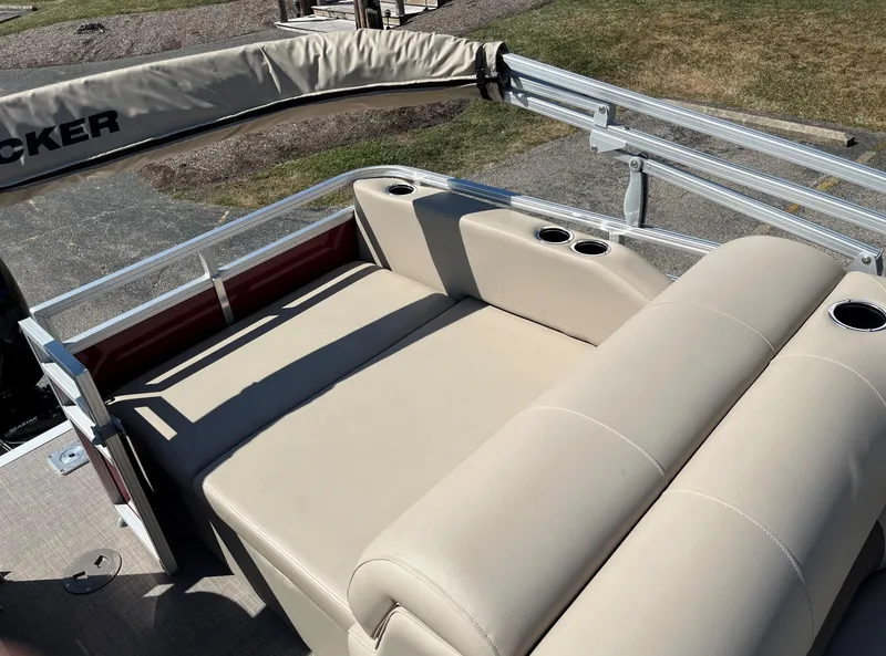 Slide: The Image of 2024 Sun Tracker Party Barge 22 RF XP3, beige seating with cup holders, outdoor setting. - 8
