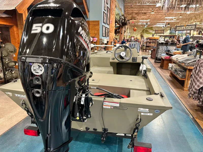 Slide: The Image of 2024 Tracker Grizzly 1648 SC boat with Mercury 50 engine displayed indoors. - 31