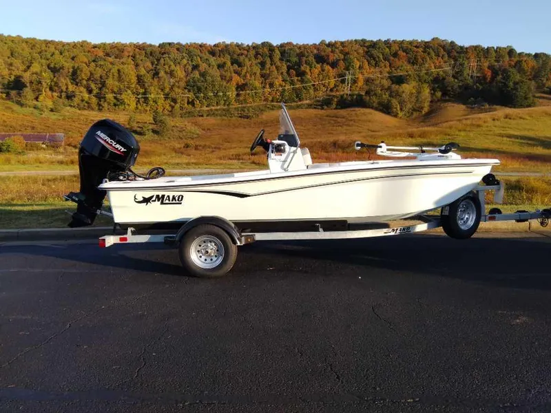 The Image of 2024 Mako Pro Skiff 15 CC boat on trailer in scenic outdoor setting. - 0