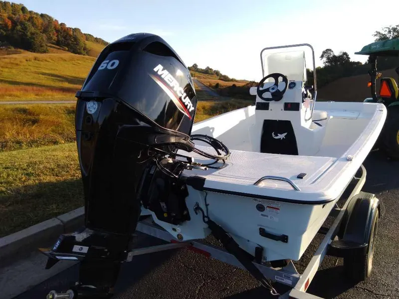 Slide: The Image of 2024 Mako Pro Skiff 15 CC with Mercury 50 outboard motor on trailer. - 2