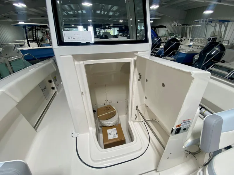 Slide: The Image of 2024 Robalo R250 boat interior storage compartment in showroom. - 27