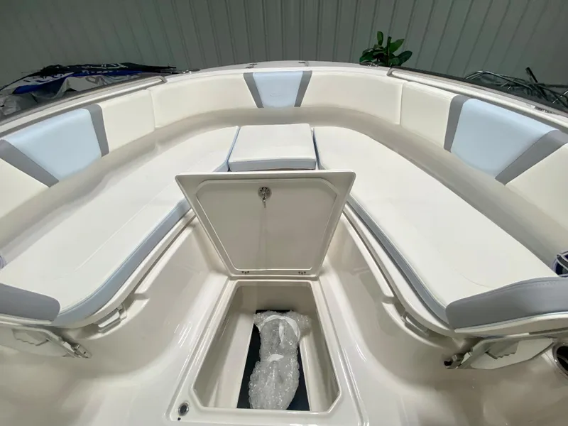 Slide: The Image of 2024 Robalo R250 boat interior with seating and storage compartments. - 28