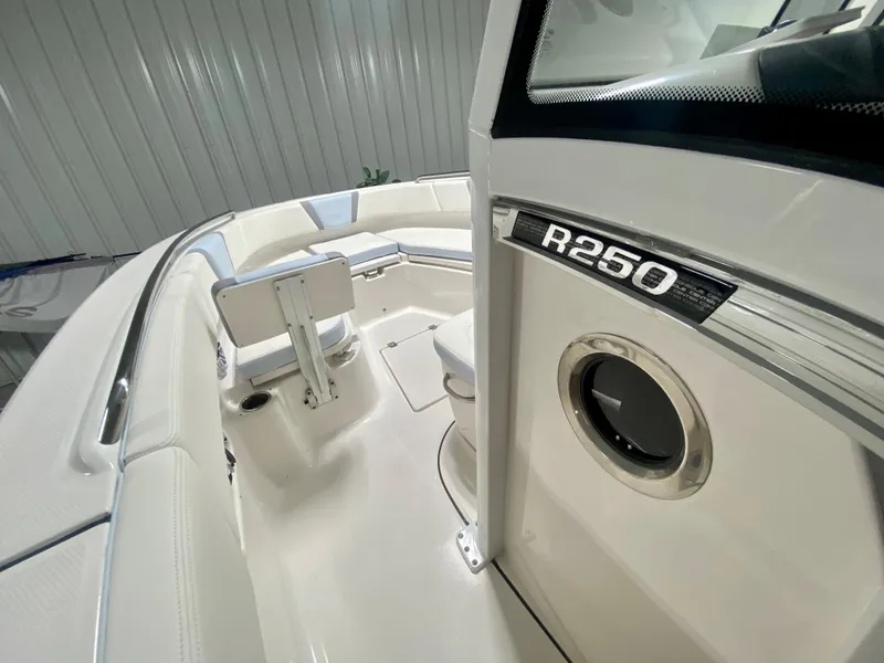 Slide: The Image of 2024 Robalo R250 boat interior with seating and storage compartments. - 29