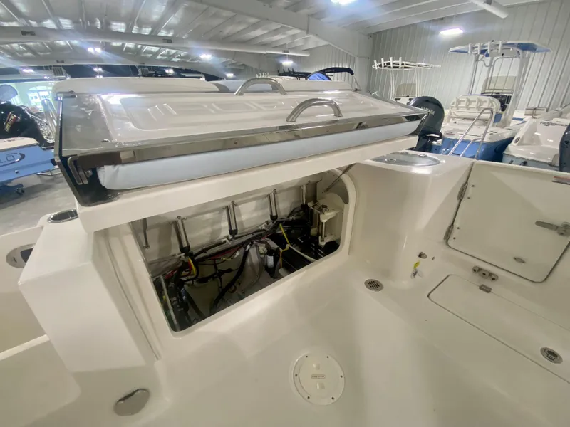 Slide: The Image of 2024 Robalo R250 boat interior with open storage compartment in a showroom. - 8