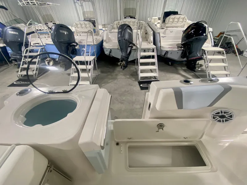 Slide: The Image of 2024 Robalo R250 boats in showroom with Yamaha outboard engines. - 10