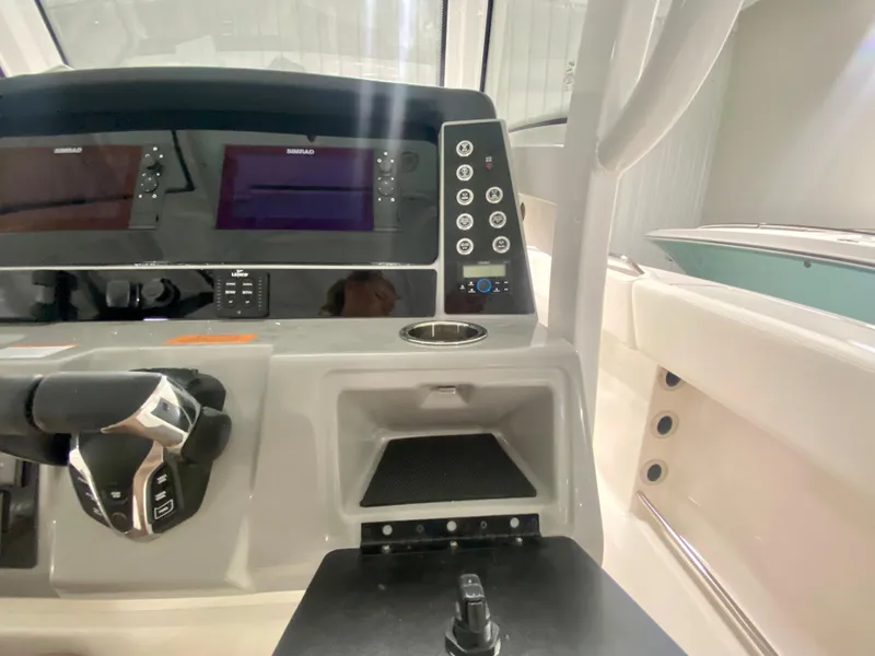 Slide: The Image of 2024 Robalo R250 boat dashboard with dual screens and control panel. - 21