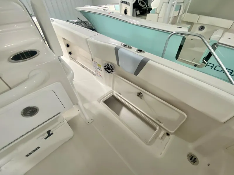 Slide: The Image of 2024 Robalo R250 boat interior with storage compartments and seating. - 22