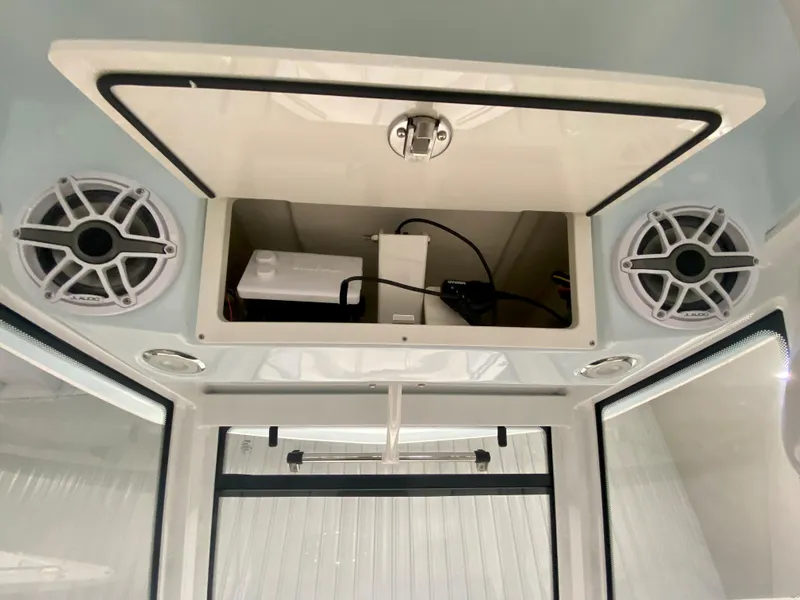 Slide: The Image of 2024 Robalo R250 boat interior with open storage compartment and speakers. - 25