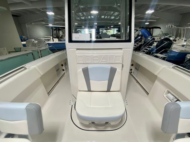 Slide: The Image of 2024 Robalo R250 boat interior with seating and storage compartments. - 26