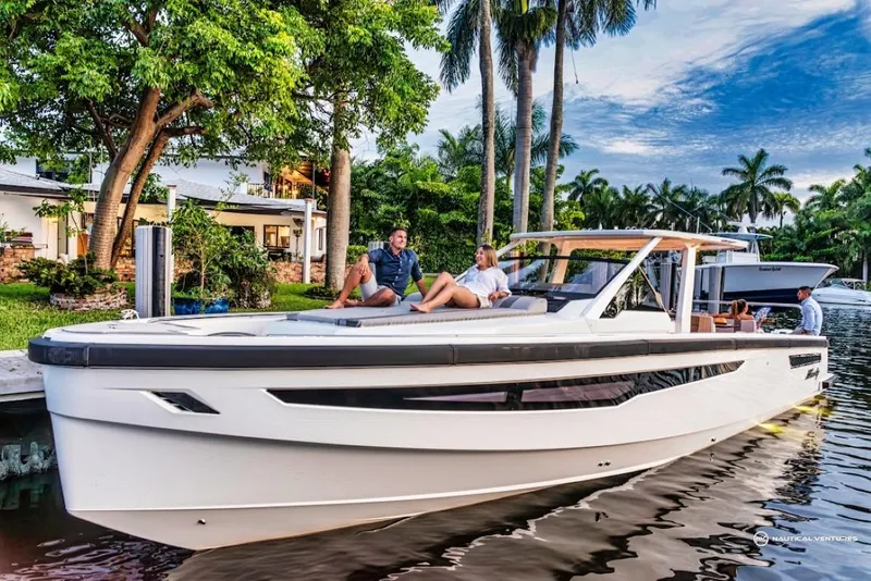Slide: The Image of 2022 Windy SR44 SX luxury yacht docked by tropical waterfront homes. - 10