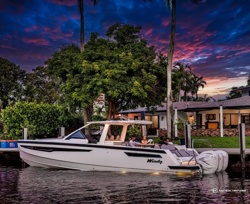 Slide: The Image of 2022 Windy SR44 SX boat docked at sunset with people onboard. - 12