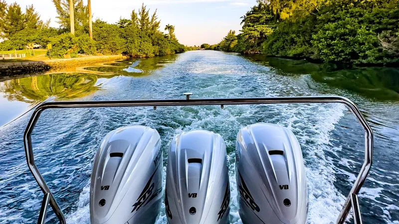 Slide: The Image of 2022 Windy SR44 SX boat with triple V8 engines cruising on a scenic river. - 16