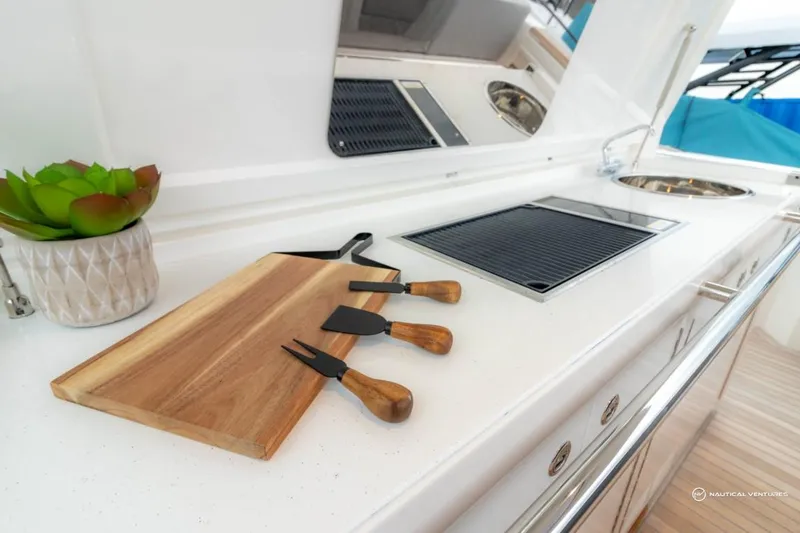 Slide: The Image of Outdoor kitchen on 2022 Windy SR44 SX yacht with cutting board and utensils. - 25