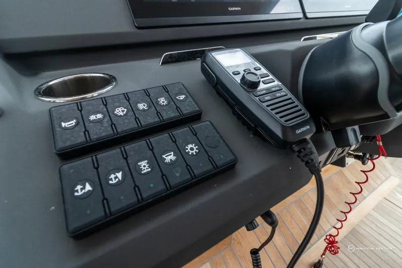 Slide: The Image of Control panel of 2022 Windy SR44 SX boat with radio and switches. - 42