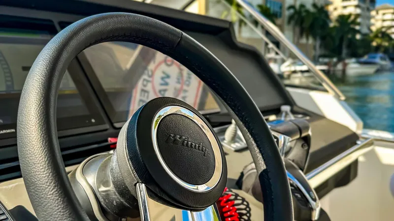 Slide: The Image of Steering wheel of a 2022 Windy SR44 SX boat with modern dashboard. - 14