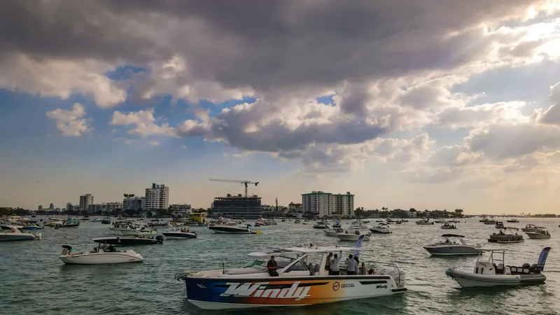 Slide: The Image of 2022 Windy SR44 SX boat on a busy waterfront with city skyline. - 17