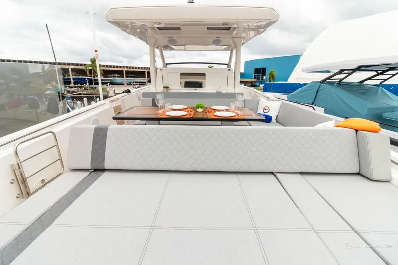 Slide: The Image of 2022 Windy SR44 SX yacht with luxurious outdoor seating and dining area. - 19