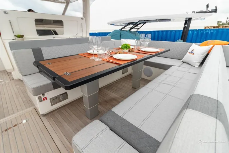 Slide: The Image of Luxurious seating area on the 2022 Windy SR44 SX yacht with a dining table. - 20