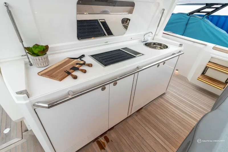 Slide: The Image of Outdoor kitchen on 2022 Windy SR44 SX yacht with cutting board and knives. - 24