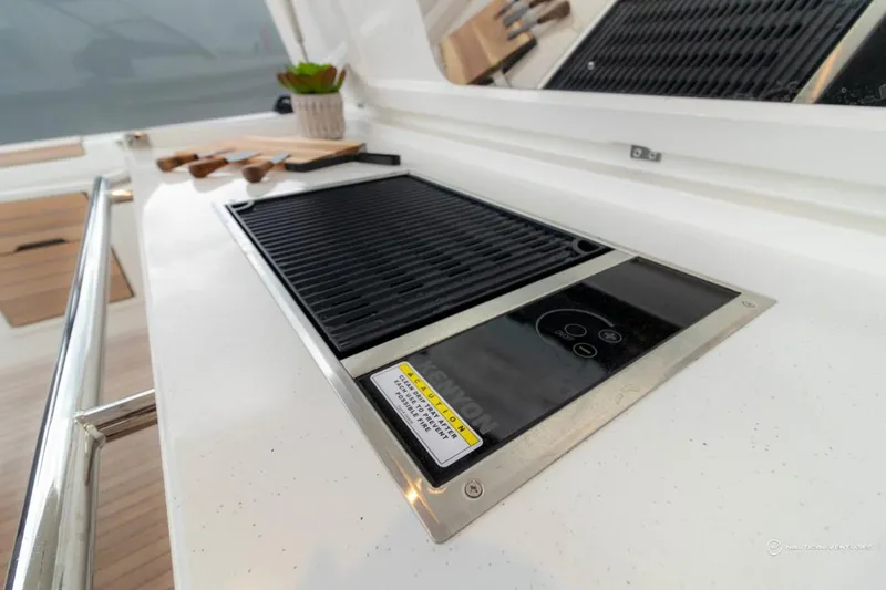 Slide: The Image of Built-in grill on the 2022 Windy SR44 SX yacht's sleek white countertop. - 26