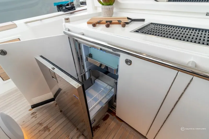 Slide: The Image of Windy SR44 SX 2022 yacht with open refrigerator and cutting board on deck. - 29
