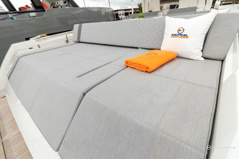 Slide: The Image of Windy SR44 SX 2022 boat with gray cushioned seating, orange towel, and branded pillow. - 34