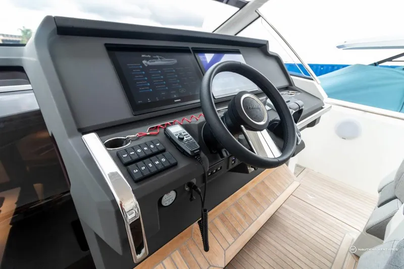 Slide: The Image of 2022 Windy SR44 SX boat helm with steering wheel, control panel, and navigation screen. - 36