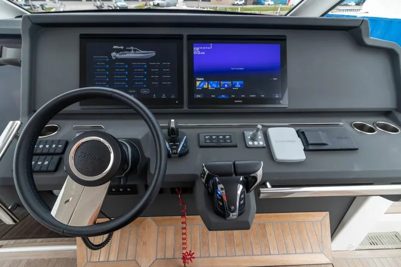 Slide: The Image of 2022 Windy SR44 SX boat dashboard with dual screens and steering wheel. - 39