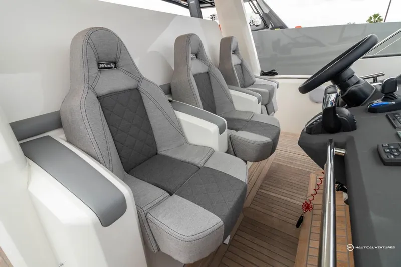 Slide: The Image of 2022 Windy SR44 SX boat interior with three grey captain seats. - 45