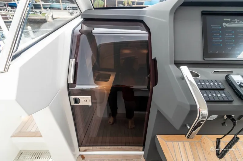 Slide: The Image of 2022 Windy SR44 SX yacht interior with control panel and cabin door. - 46