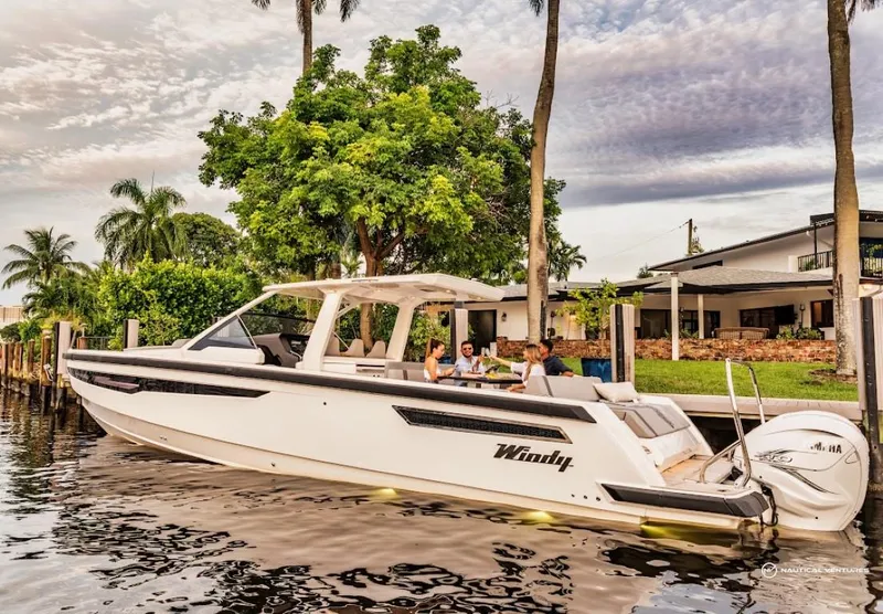 Slide: The Image of 2022 Windy SR44 SX boat docked by a waterfront home with people onboard. - 9