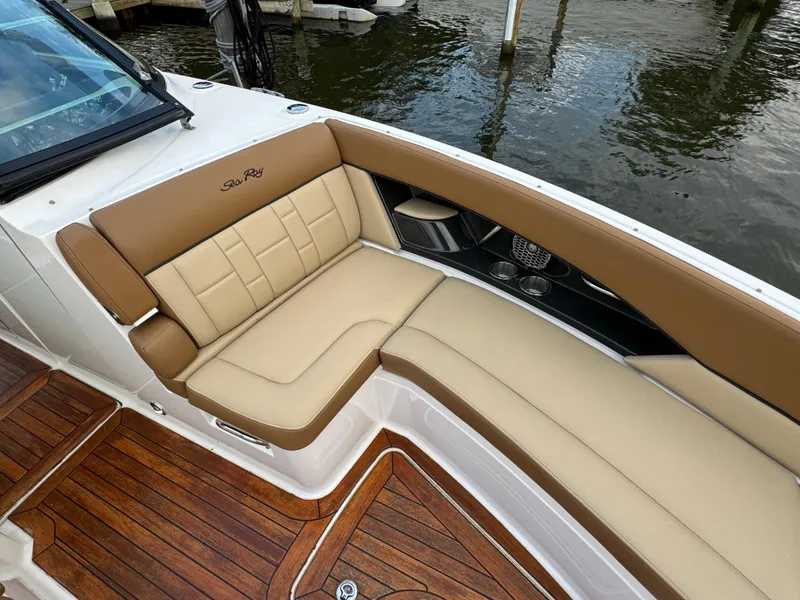 Slide: The Image of Luxurious seating on 2015 Sea Ray 350 SLX boat with tan upholstery and wood flooring. - 29