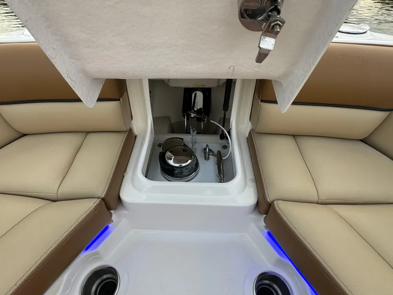 Slide: The Image of 2015 Sea Ray 350 SLX boat interior with seating and storage compartment. - 31
