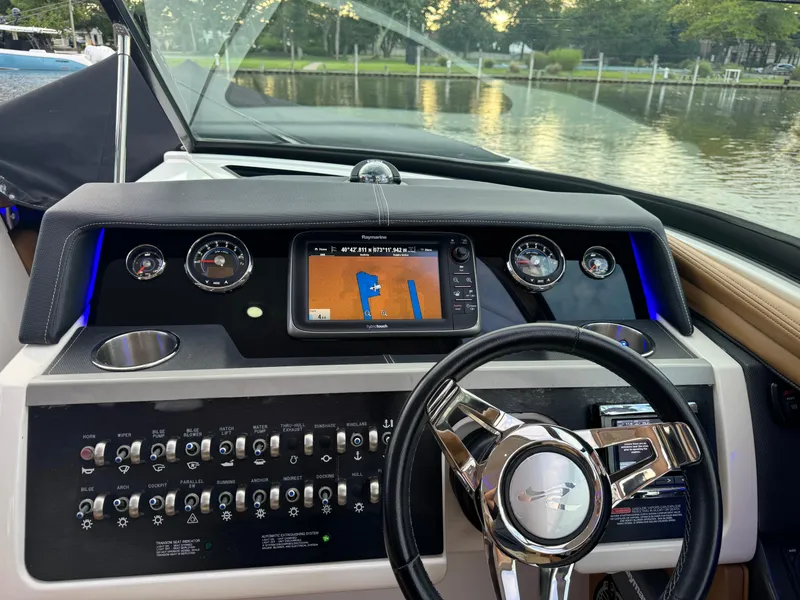 Slide: The Image of 2015 Sea Ray 350 SLX dashboard with navigation system and controls. - 38