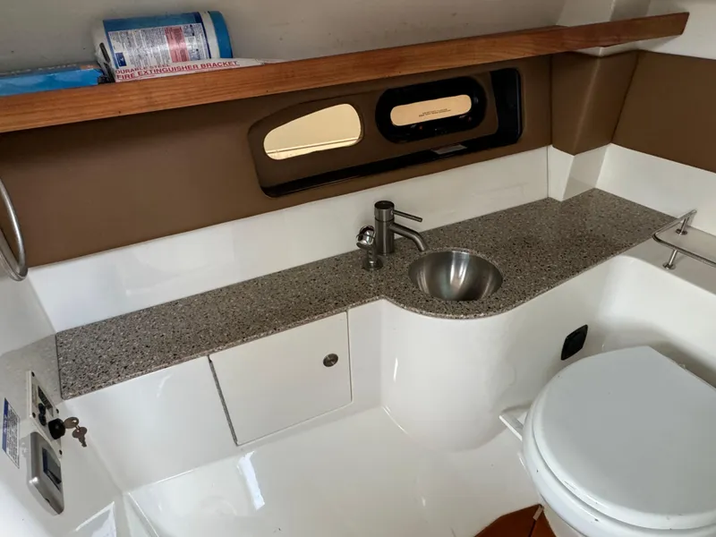 Slide: The Image of 2015 Sea Ray 350 SLX boat bathroom with sink, toilet, and window. - 35