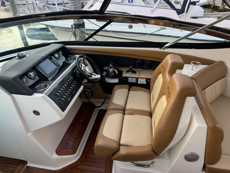 Slide: The Image of 2015 Sea Ray 350 SLX boat interior with leather seats and modern dashboard. - 17