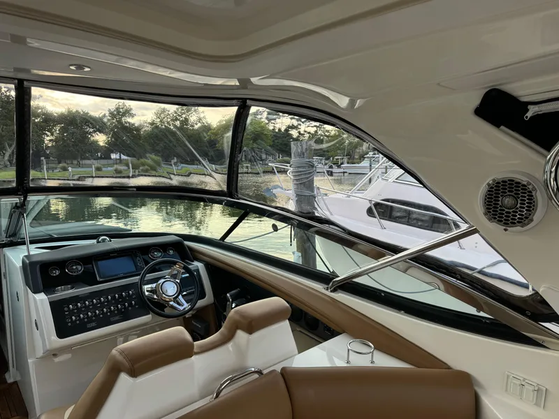 Slide: The Image of Interior view of 2015 Sea Ray 350 SLX boat with modern dashboard and steering wheel. - 16